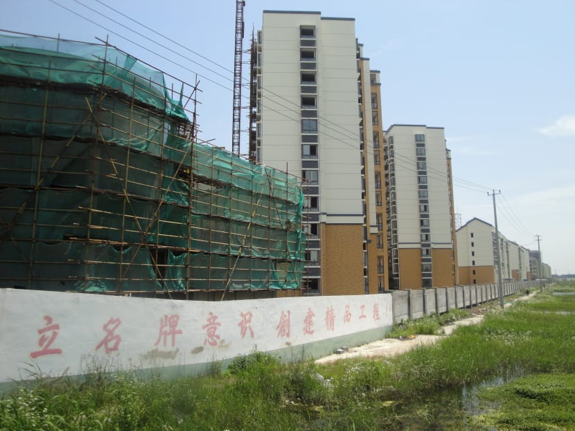 Residential blocks under construction in Chongming Island, Shanghai. After four years of government curbs, home sales and construction in China are sliding. Photo: Bloomberg
