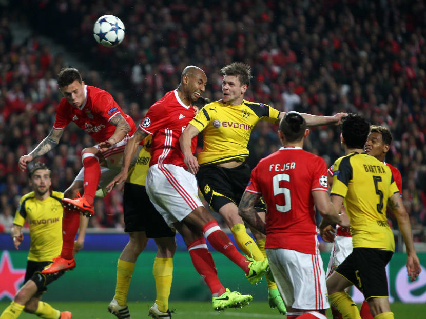 Footballers jump up to challenge for the ball in a UEFA Champions League match. Photo: Reuters