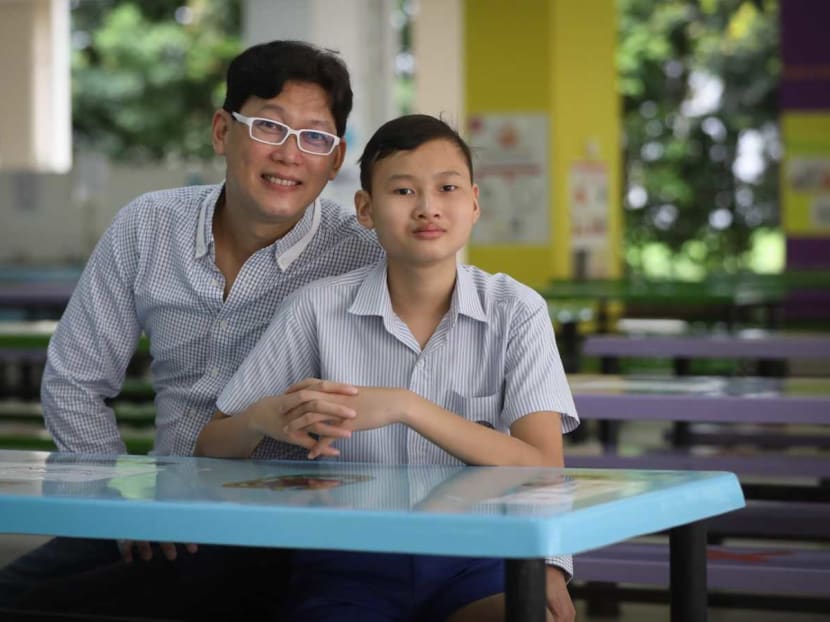 Teh Jun Hang and his father Nicholas Teh. After a long road to recovery, Jun Hang, now aged 13, was one of the 39,995 Primary 6 pupils who collected their Primary School Leaving Examination results on Wednesday.