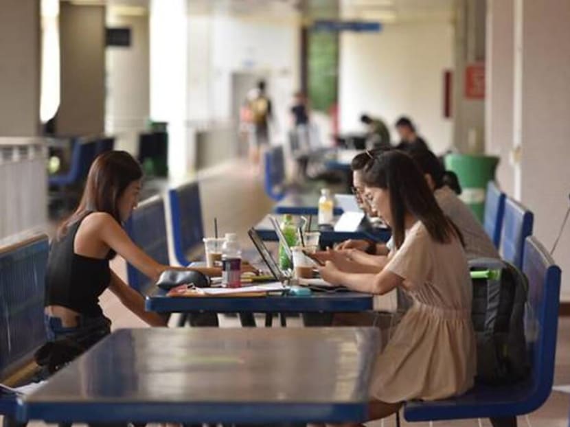 Students sit at a common area at the National University of Singapore.