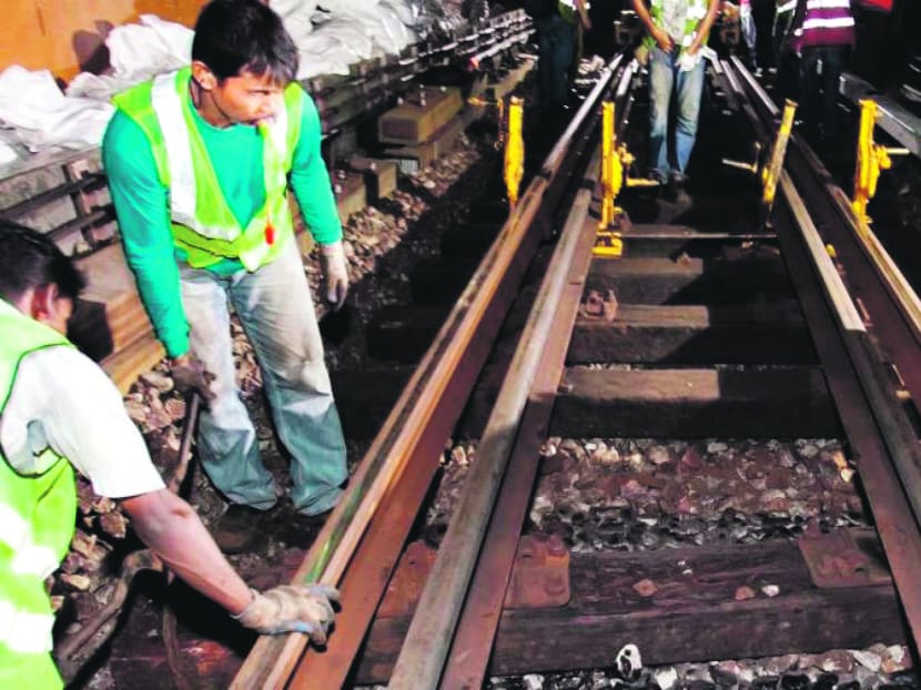 SMRT staff at work as they replace timber sleepers. Photo: SMRT