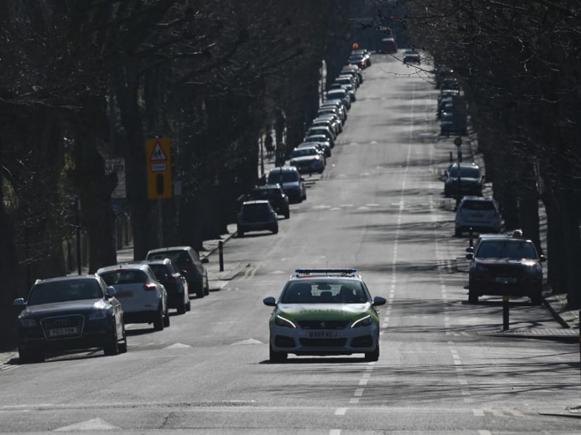 A police car patrols on a street in Tooting, south London, on March 24, 2020 A police car patrols on a street in Tooting, south London, on March 24, 2020