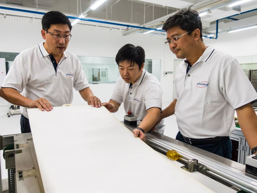 (From left) Nano Sun co-founder and NTU associate professor Darren Sun, engineer Zhang Lilin and managing director Wong Ann Chai inspecting a completed membrane module.