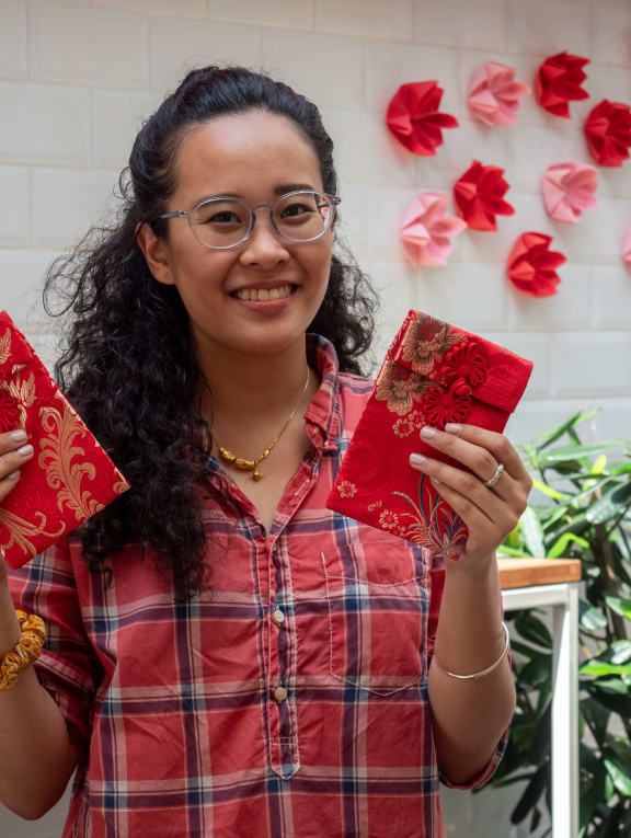 Ms Melissa Lam holding a pair of reusable cloth hongbao.