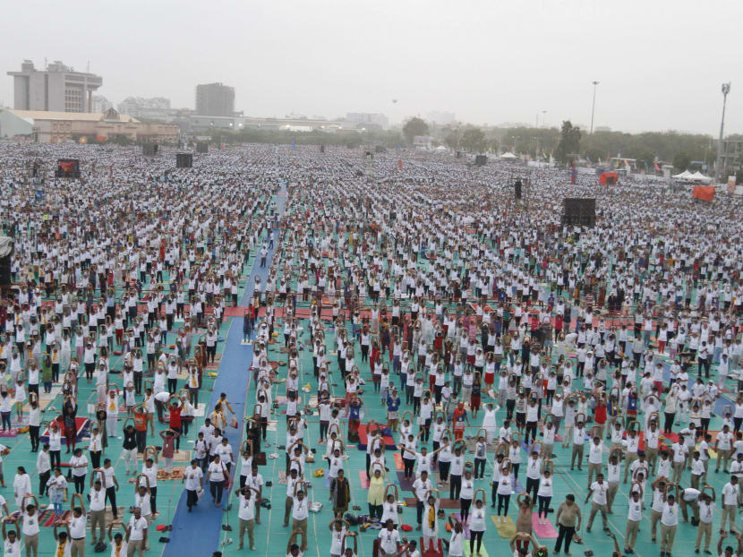Yoga practitioners pause to stretch and pose for international event
