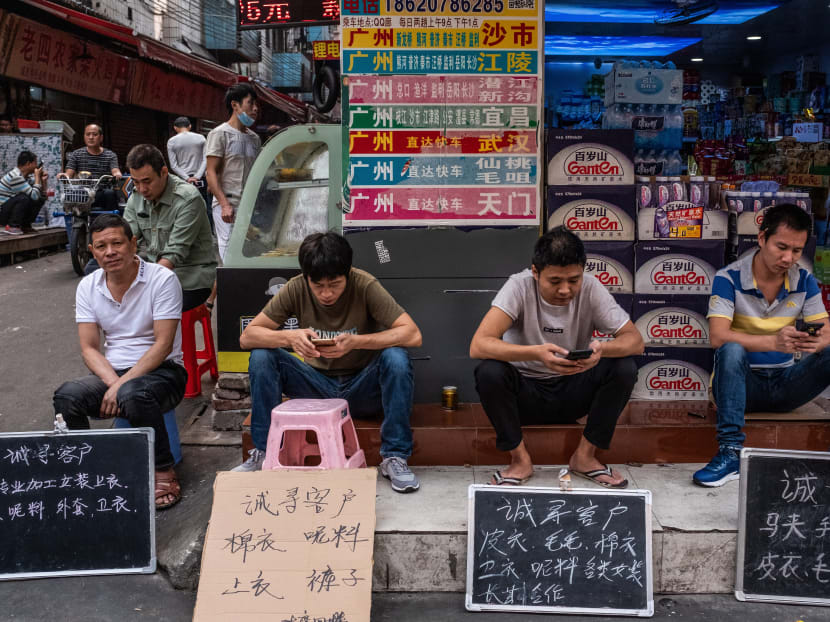 Employees from a garment factory sit behind signs that say ''Looking for customers'' in Chinese, in Guangzhou. The author says China could rethink its practice of setting GDP growth targets. Employees from a garment factory sit behind signs that say ''Looking for customers'' in Chinese, in Guangzhou. The author says China could rethink its practice of setting GDP growth targets.