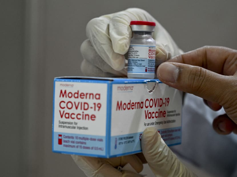 A health worker checks a box of the Moderna Covid-19 coronavirus vaccine donated by the US, during a booster vaccination drive at the Zainoel Abidin hospital in Banda Aceh on August 9, 2021.