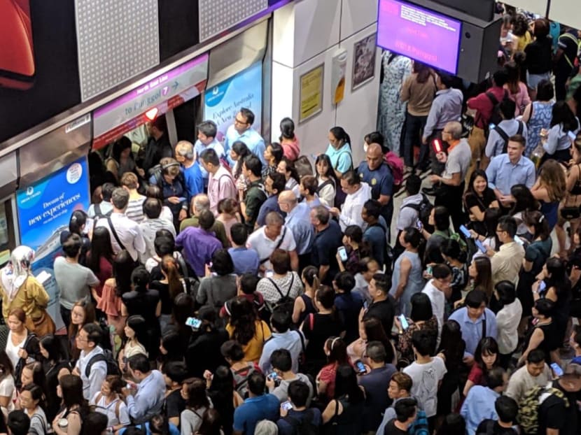 Passengers evacuating the incident train in which a passenger's handphone was seen emitting smoke on Tuesday evening.