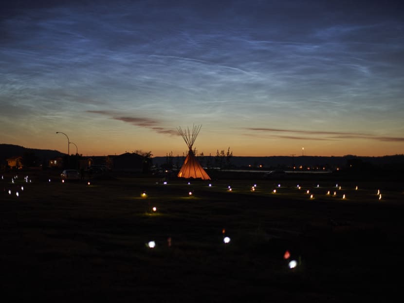 The grim development follows the discovery of remains of 215 children in unmarked graves at the former Kamloops Indian Residential School in British Columbia in May 2021 and 751 more unmarked graves at another school in Marieval, Saskatchewan in June 2021. Solar lights and flags mark the spots of the 751 on June 28, 2021.