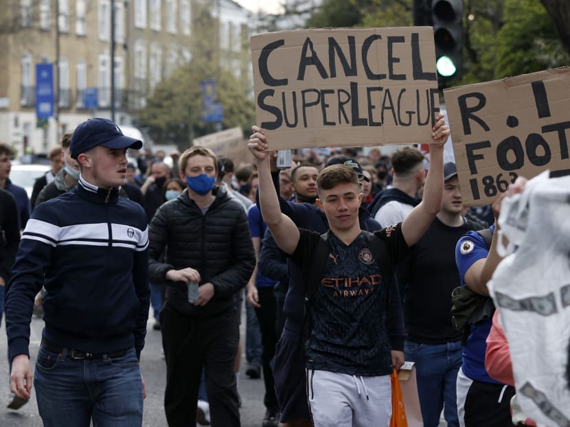 Football supporters demonstrate against the proposed European Super League outside of Stamford Bridge football stadium in London, UK on April 20, 2021, ahead of the English Premier League match between Chelsea and Brighton and Hove Albion. Football supporters demonstrate against the proposed European Super League outside of Stamford Bridge football stadium in London, UK on April 20, 2021, ahead of the English Premier League match between Chelsea and Brighton and Hove Albion.
