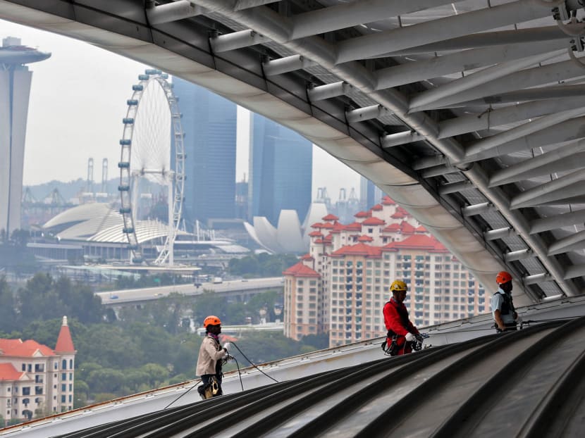 Workers carrying out  maintenance works on the Singapore Sports Hub roof top. TODAY file photo