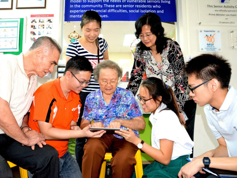 Mr Jedi Pan (orange shirt) has developed an app on MediShield Life and the Pioneer Generation Package for residents. Photo: Pan Zhengxiang