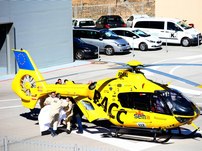 Fernando Alonso being transferred from the medical centre to the helicopter after crashing during Day Four of Formula One Winter Testing at the Circuit de Catalunya on Feb 22 in Montmelo, Spain. Photo: Getty Images