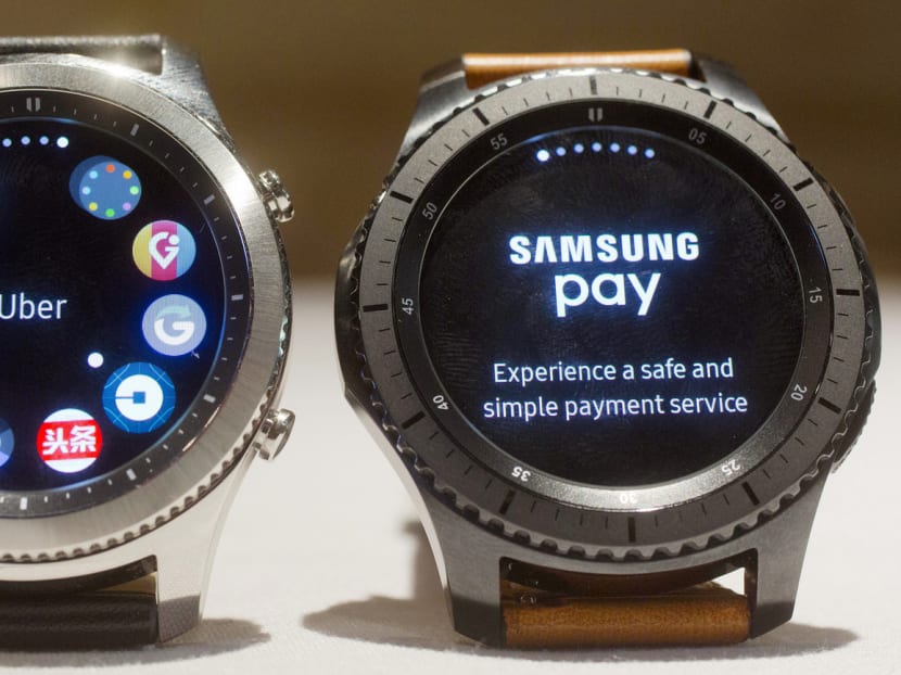 Samsung’s Gear S3 Classic version (left) displays a series of apps, while the Frontier version (right) displays Samsung Pay, which both support. The company is seeking to outshine Apple with the new products. Photo: AP