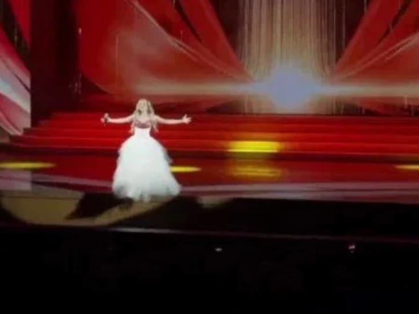 Russian singer falls off stage, breaks foot, continues singing – while lying face down