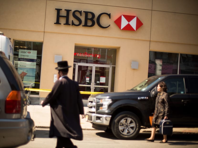 Pedestrians pass a HSBC bank branch that was robbed in the Brooklyn borough of New York, April 11, 2016. Employees opening the bank Monday morning found a tunnel through the ceiling into the vault and hundreds of thousands of dollars missing.  Photo: NYT