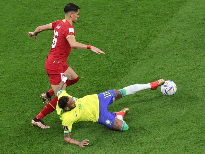 Brazil's forward Neymar and Serbia's midfielder Sasa Lukic fight for the ball during the Qatar 2022 World Cup Group G football match between Brazil and Serbia at the Lusail Stadium in Lusail, north of Doha on Nov 24, 2022.
