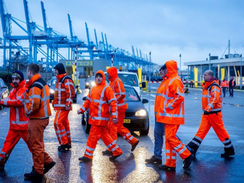 Container port workers walk past a picket line at the port in Rotterdam on Jan 7, 2016 during a strike calling for job guarantees until 2020. Photo: AFP Container port workers walk past a picket line at the port in Rotterdam on Jan 7, 2016 during a strike calling for job guarantees until 2020. Photo: AFP