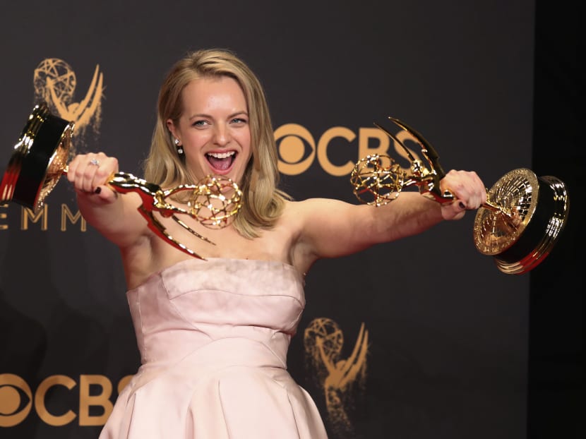 Elizabeth Moss poses backstage with her awards for Outstanding Lead Actress in a Drama Series and Outstanding Drama Series for The Handmaid's Tale on Sept 17, 2017.  Photo: Reuters