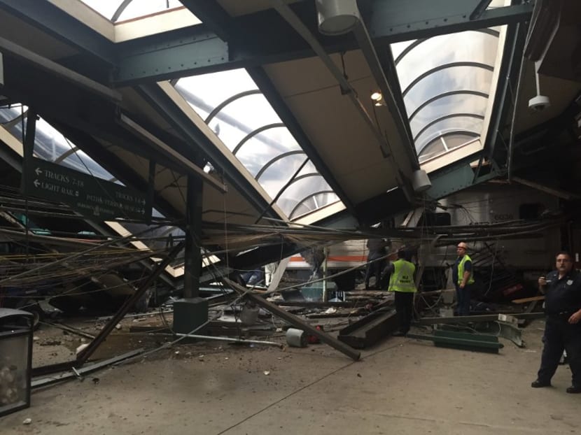 A NJ Transit train seen through the wreckage after it crashed in to the platform at the Hoboken Terminal. Photo via AFP