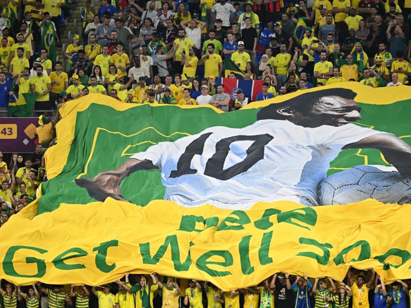 Brazil supporters display a banner depicting Brazilian football legend Pele and reading "Pele, get well soon" during the Qatar 2022 World Cup round of 16 football match between Brazil and South Korea at Stadium 974 in Doha on Dec 5, 2022.