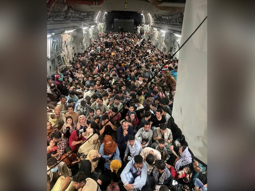 Evacuees crowd the interior of a US Air Force C-17 Globemaster III transport aircraft, carrying some 640 Afghans to Qatar from Kabul, Afghanistan on Aug 15, 2021.