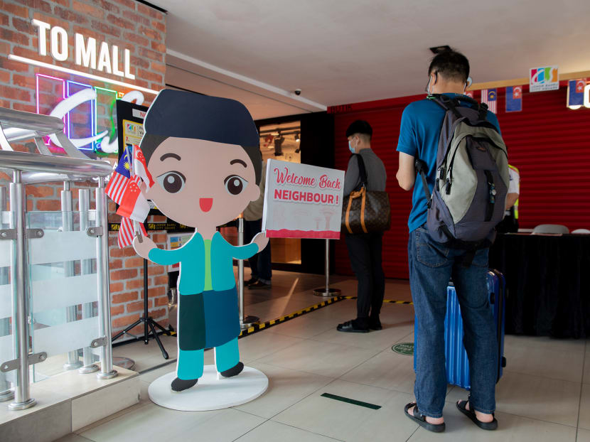 A standee and signage outside Johor Bahru City Square mall with a message welcoming back Singapore visitors to Malaysia on April 1, 2022.