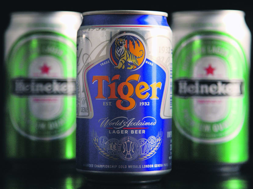 Cans of Heineken NV beer and Asia Pacific Breweries Ltd.'s Tiger beer. Photo: Bloomberg
