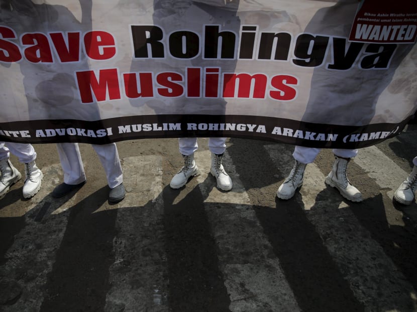 Indonesia's hardline Islamic Defenders Front members hold a poster during protest against what they say are the killing of Muslims. Senior officials from across Asia will meet on Friday, May 29, 2015, in Bangkok to tackle the growing problem of the Rohingya people. Photo: Reuters