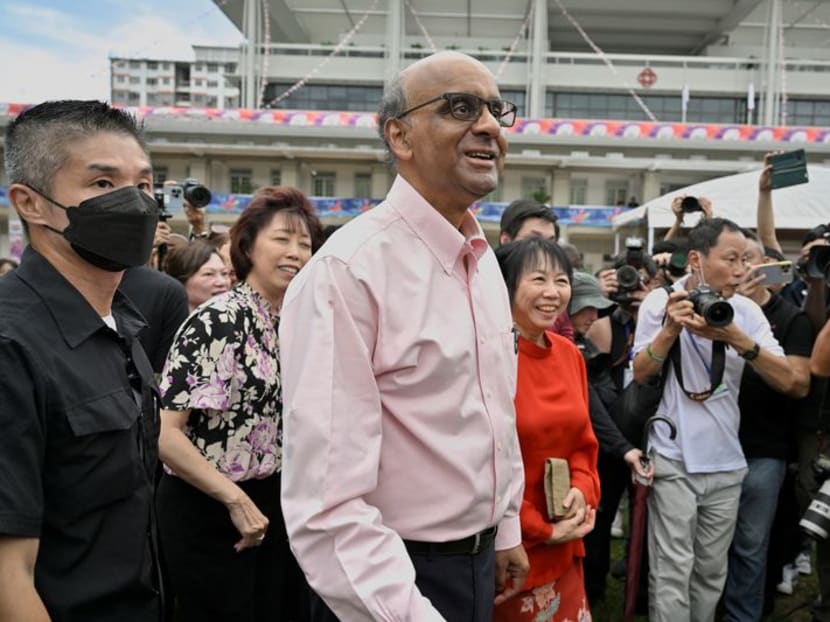 Mr Tharman Shanmugaratnam and his wife, Jane Yumiko Ittogi (in red) are seen at the nomination centre in Singapore on Aug 22, 2023.