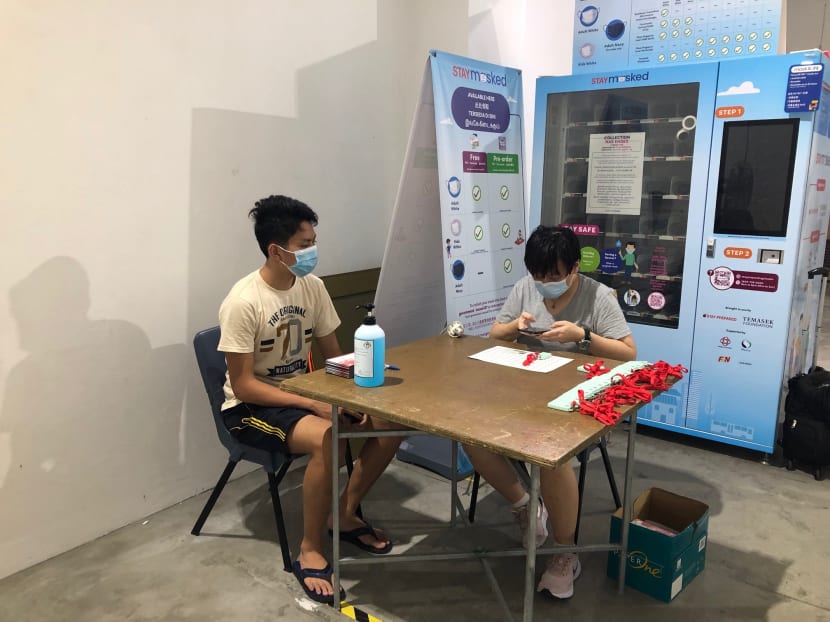 A resident collecting his TraceTogether token at Buona Vista Community Club on Oct 25, 2020.