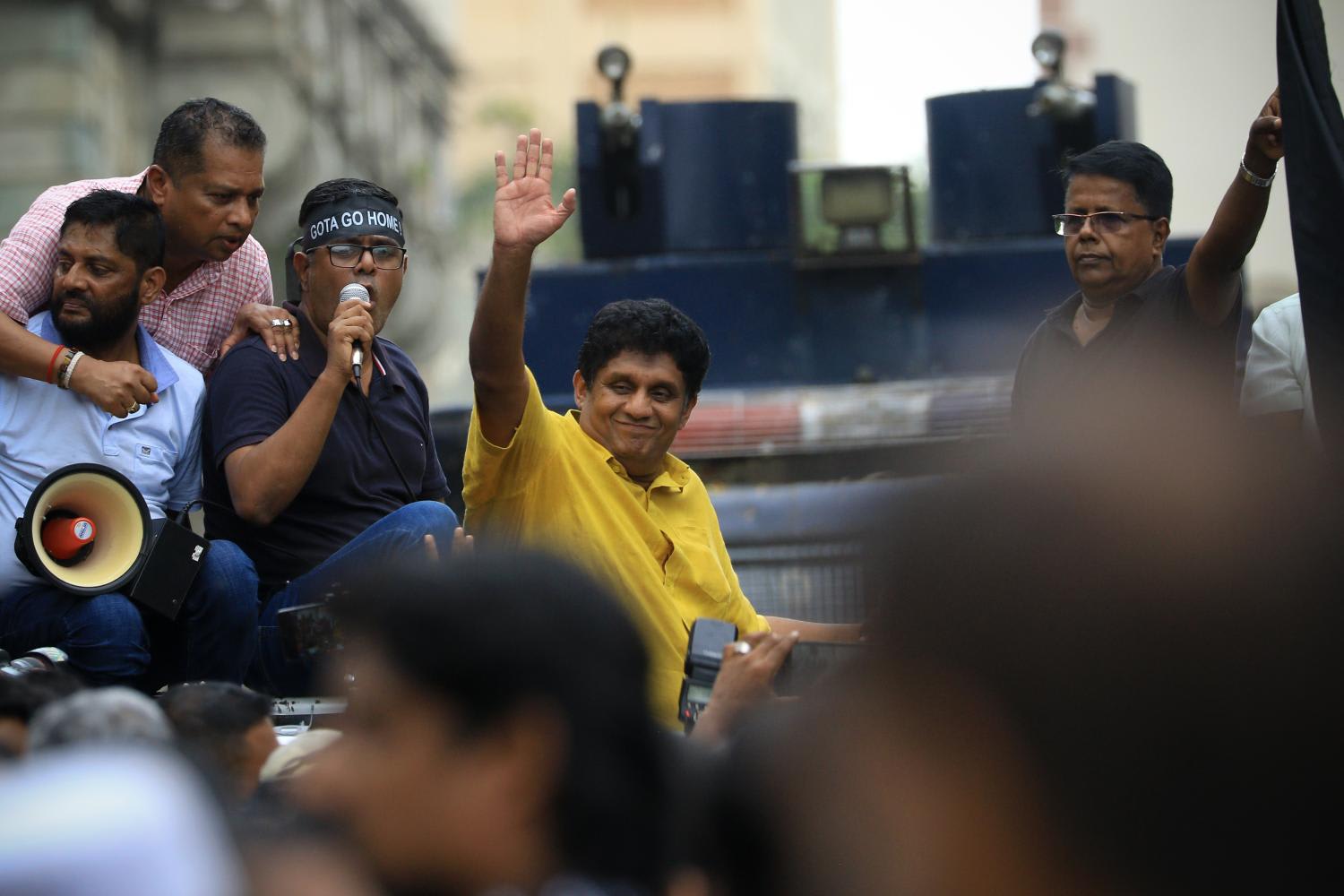 Sri Lanka opposition leader&nbsp;Sajith&nbsp;Premadasa&nbsp;acknowledges his supporters after stepping in to a barricade to protest in front of president Gotabaya Rajapaksa's official residence demanding president's resignation at Colombo, Sri Lanka on June 30, 2022.