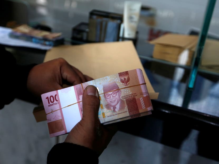 Indonesian rupiah banknotes are seen at a money changer in Jakarta.