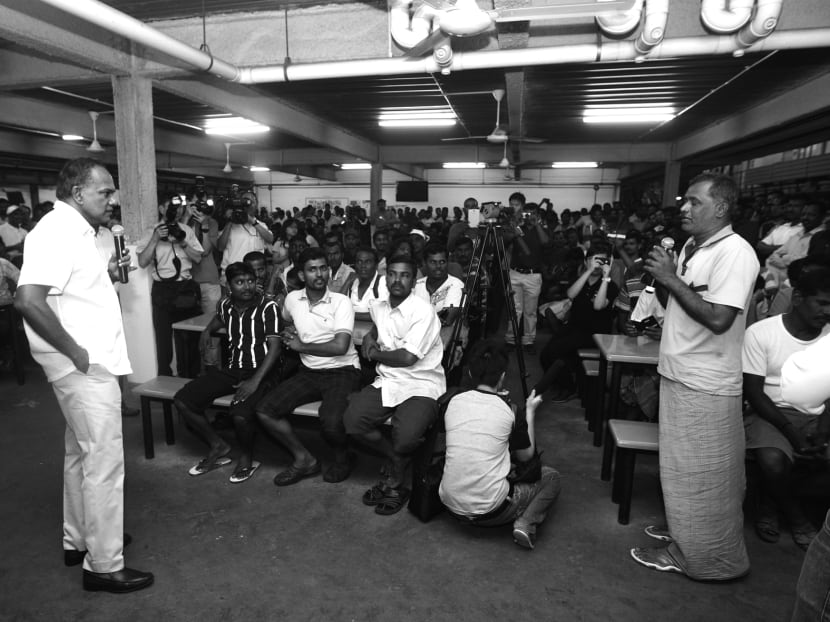 Minister K Shanmugam chatting with foreign workers at their dormitory after the Little India riot. The Government has ruled out work-related grievances as a cause of the incident. TODAY FILE PHOTO