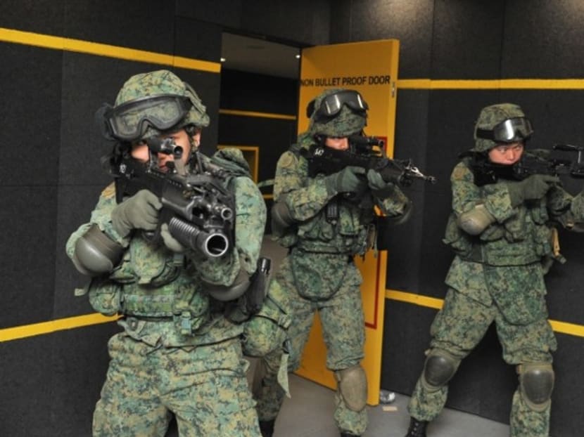 Soldiers undergo training in the indoor firing range complex. Photo: MINDEF