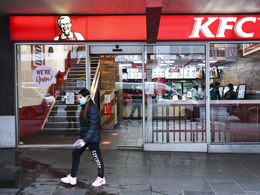 A person walks past a KFC outlet in Melbourne's central business district on Wednesday, July 15, 2020. Australians under lockdown for the second time are struggling with fresh virus restrictions, with police saying on July 15 they had dished out hundreds of fines including to people playing Pokemon Go and eating KFC.