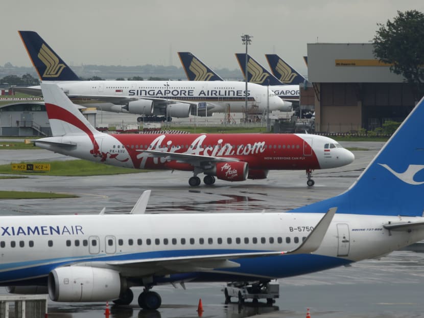 AirAsia's QZ8501 from Surabaya to Singapore, taking the same code as the missing plane which took off 24 hours earlier, taxis at Changi Airport in Singapore Dec 29, 2014. Photo: Reuters