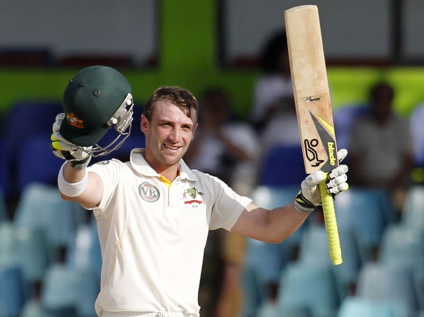 In this Sept. 19, 2011 file photo Australia's batsman Phillip Hughes celebrates after scoring a century during the fourth days' play of the third cricket test match between Australia and Sri Lanka in Colombo, Sri Lanka. Photo: AP