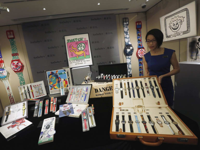 Sharon Chan, Sotheby's Head of Watches Asia, displays a set of James Bond 40th anniversary watches as part of a 5,800 Swatch watches and related artworks collection during a preview in Hong Kong today (March 10). Photo: Reuters