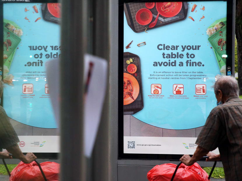 A poster at a bus-stop in Yishun informs the public of the NEA’s announcement earlier this week that from Sept 1, diners at hawker centres risk being warned or fined if they do not return their dirty trays and crockery, and clear litter on their tables after a meal.