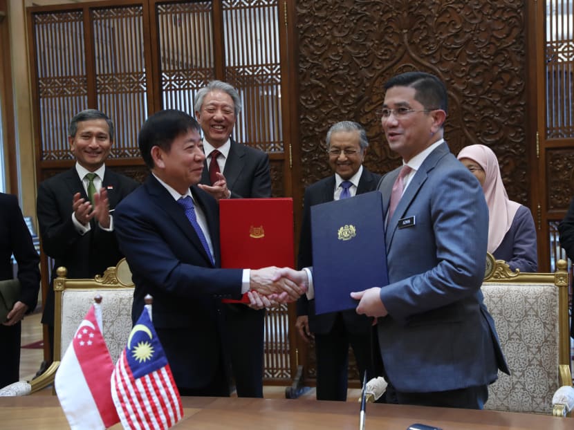 Singapore’s Transport Minister Khaw Boon Wan and Malaysia’s Economic Affairs Minister Mohamed Azmin Ali signing an agreement to defer the Kuala Lumpur-Singapore High Speed Rail project on Wednesday (Sept 5).