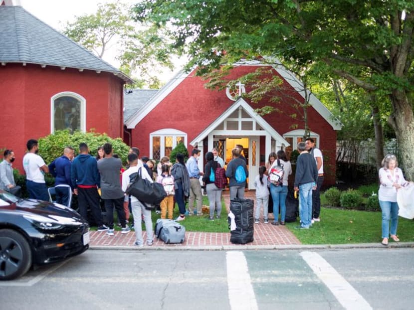 FILE PHOTO: Venezuelan migrants stand outside St. Andrew's Church in Edgartown, Massachusetts, U.S. September 14, 2022. Ray Ewing/Vineyard Gazette/Handout via REUTERS/File Photo FILE PHOTO: Venezuelan migrants stand outside St. Andrew's Church in Edgartown, Massachusetts, U.S. September 14, 2022. Ray Ewing/Vineyard Gazette/Handout via REUTERS/File Photo