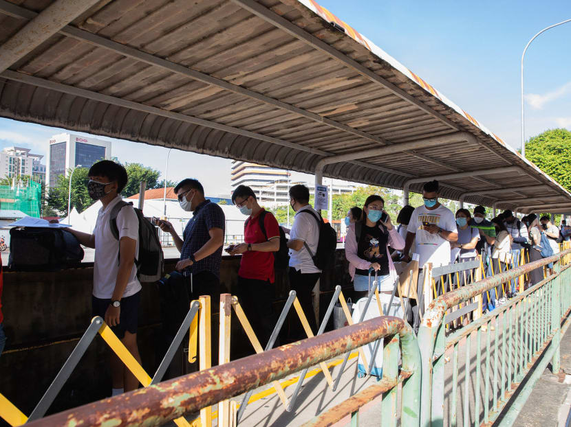 Passengers queuing for the first VTL bus to Malaysia at Queen Street Bus Terminal on Nov 29, 2021.