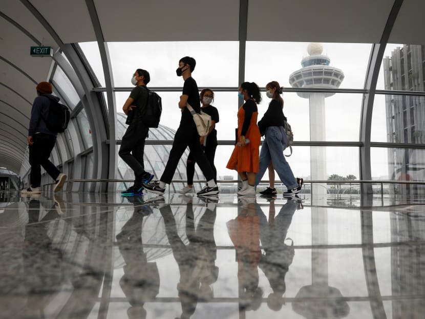 People passing the control tower of Changi Airport. People passing the control tower of Changi Airport.