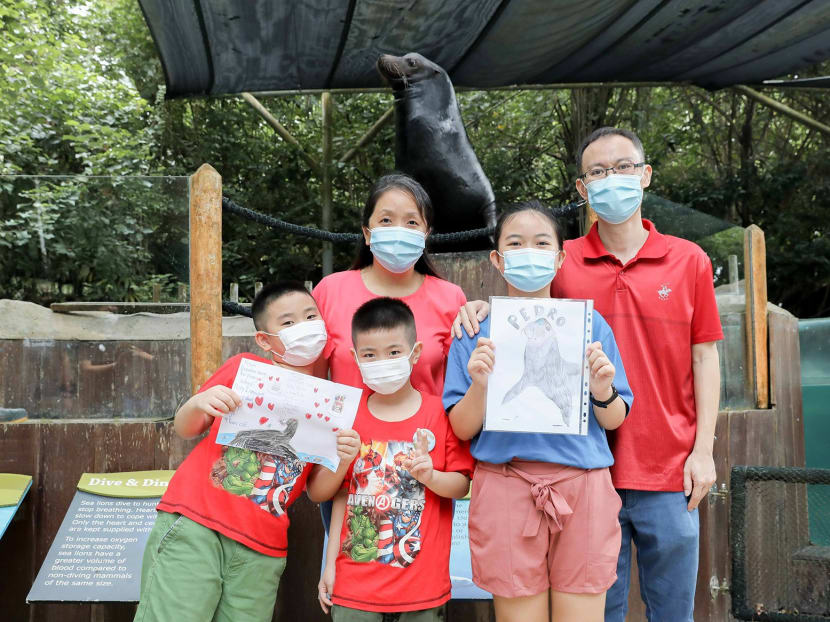 Julia Heng (front, first from right) with her brothers and parents Cindy Heng and Raymond Heng. Pedro, the Singapore zoo's Californian sea lion, is in the background.