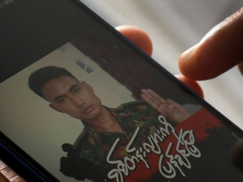 This screengrab provided via AFPTV and taken on March 14, 2021 shows Mr Shing Ling, a former Myanmar soldier who deserted the military to join the democracy movement in the aftermath of the military coup, looking at his Facebook profile showing his picture wearing a military uniform and holding up the three finger salute in Yangon.
