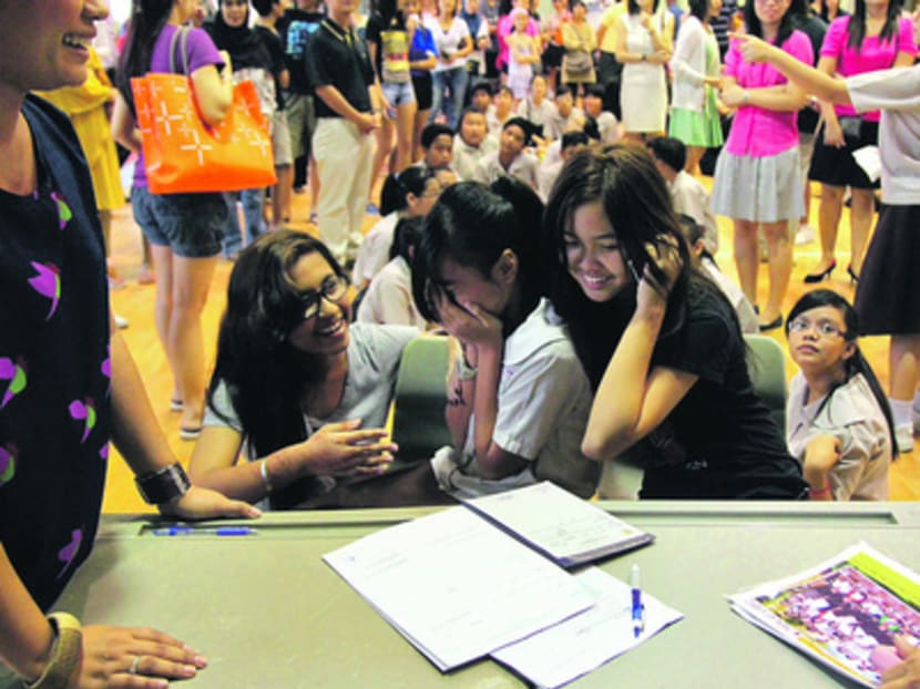 A student celebrates with her friends after seeing her PSLE results at Boon Lay Garden Primary School. TODAY FILE PHOTO