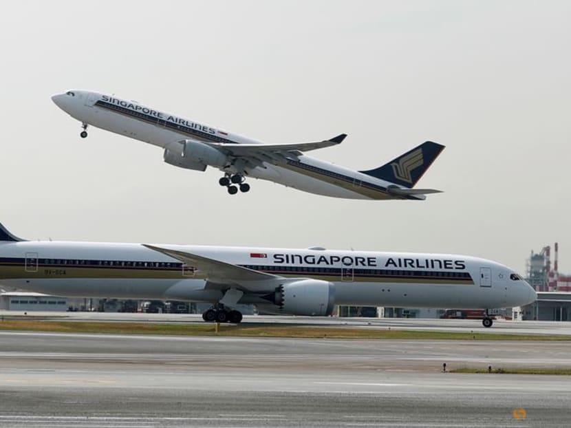 A Singapore Airlines Airbus A330-300 plane takes off behind a Boeing 787-10 Dreamliner at Changi Airport in Singapore on March 28, 2018.