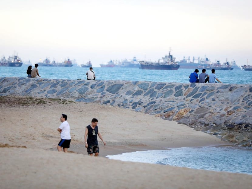 Beach-goers seen along East Coast Park. The Government is planning to have more reclaimed land along the coastal area in the future.