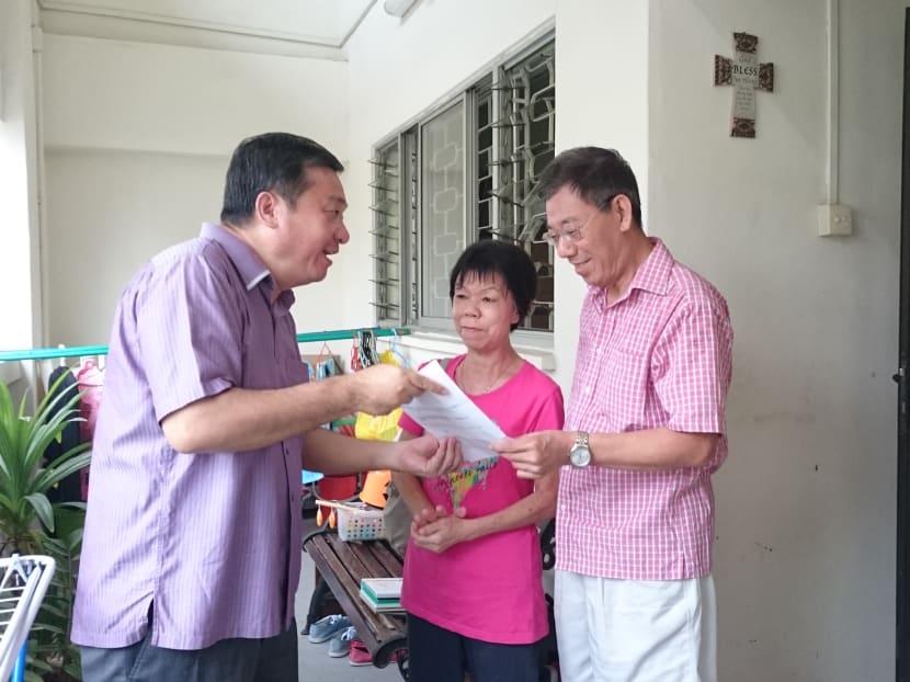 MP for Potong Pasir Sitoh Yih Pin delivered to affected residents the letter for approval for the lift upgrading programme. The two residents here are Mr and Mrs Lim who have lived here for more than 20 years. Photo: Lee Yen Nee